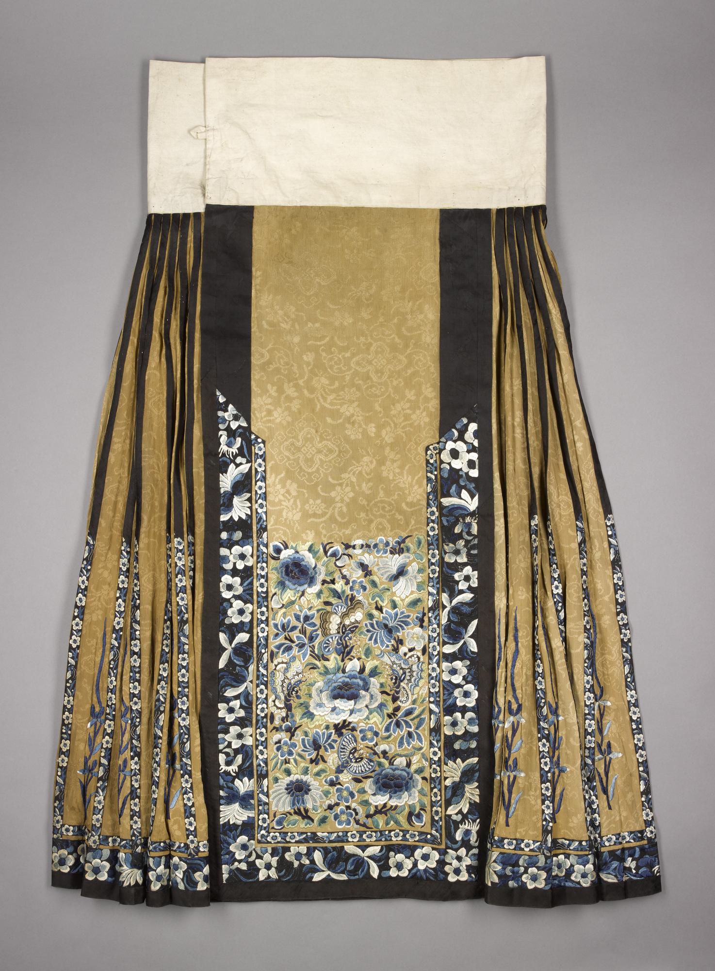 Skirt of figured silk, embroidered with a floral pattern in blue, green and white: China, Qing Dynasty, late 19th century.