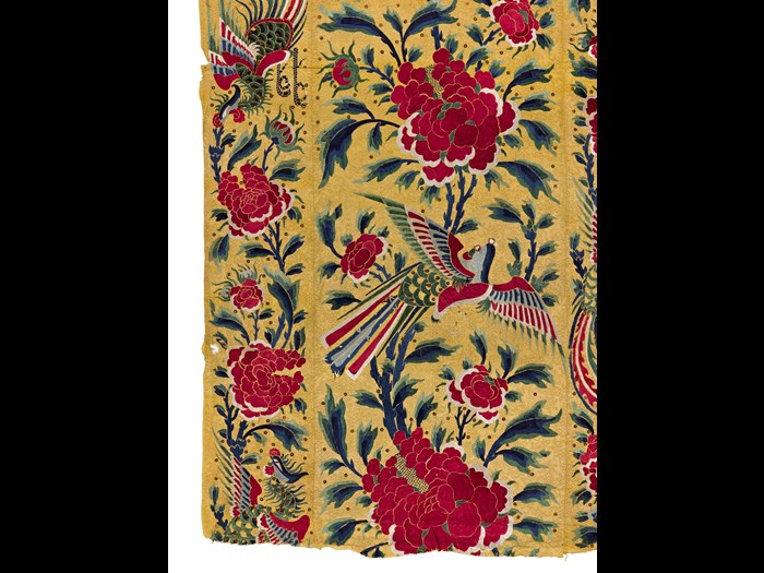 Hanging consisting of four pieces of yellow silk brocade sewn together, studded with sequins, embroidered with coloured silks and showing a design of birds, flowers and lions: China, 19th century.