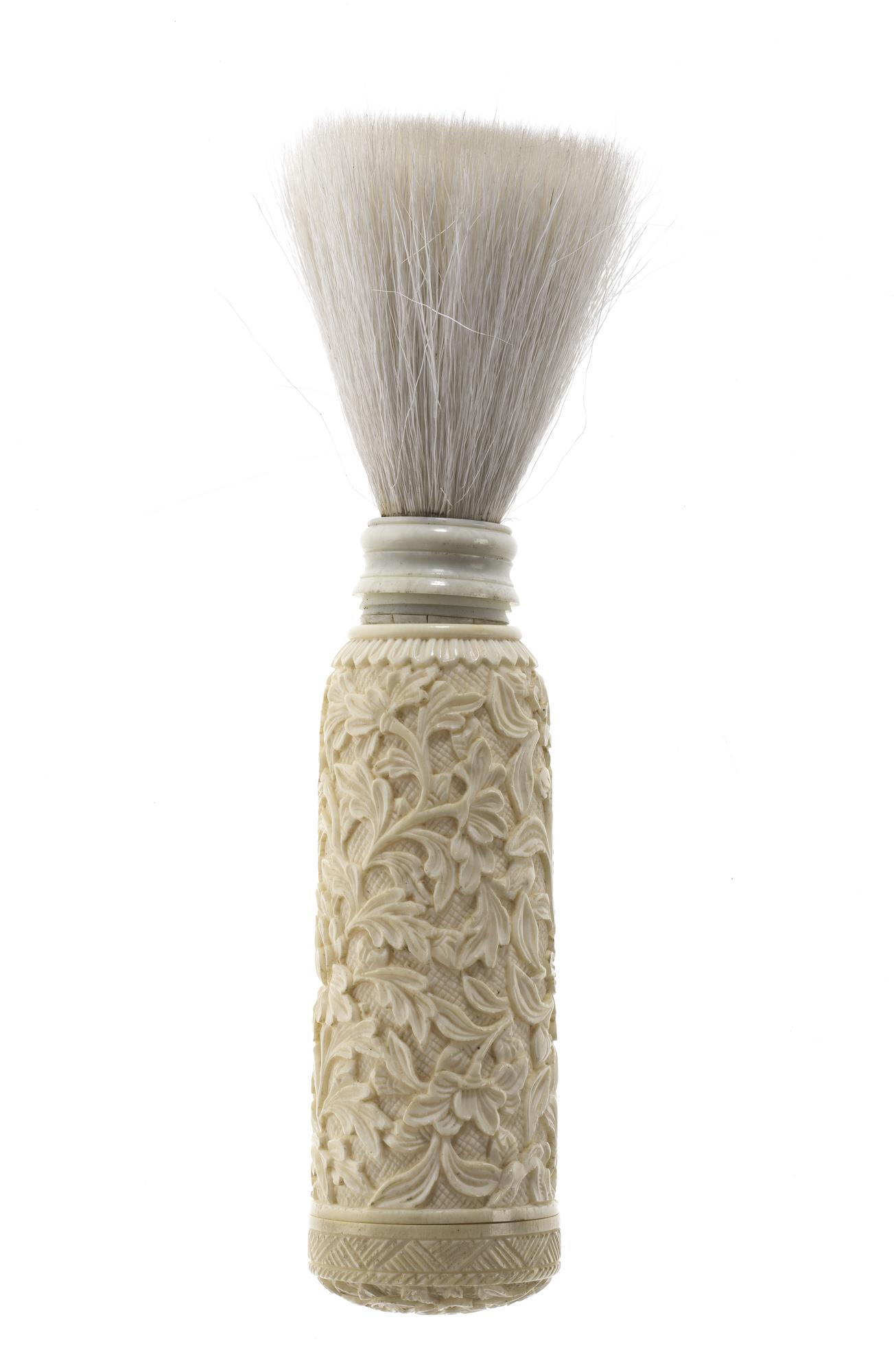 Shaving-brush case of ivory, roughly cylindrical and carved in relief with birds, flowers and foliage: China, 19th century AD.