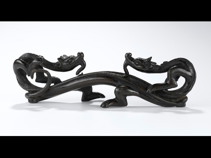 Bronze pen rest in the form of two conjoined archaic dragons facing one another: China, probably Ming Dynasty, 1368-1644.