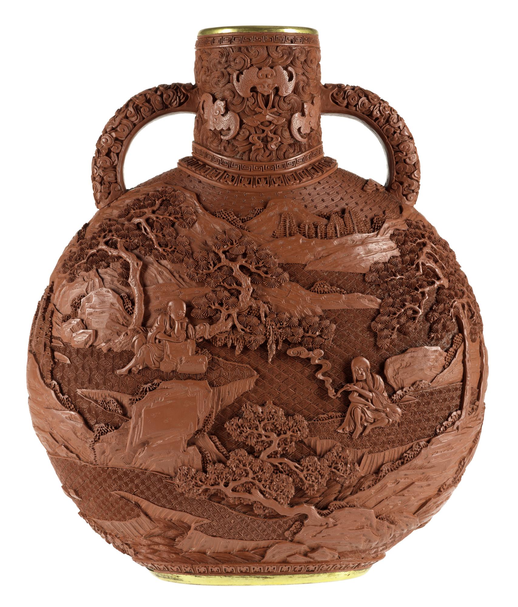 Moon flask of carved red lacquer on a porcelain body, decorated on both sides with a landscape: China, Qing dynasty, late 19th century.