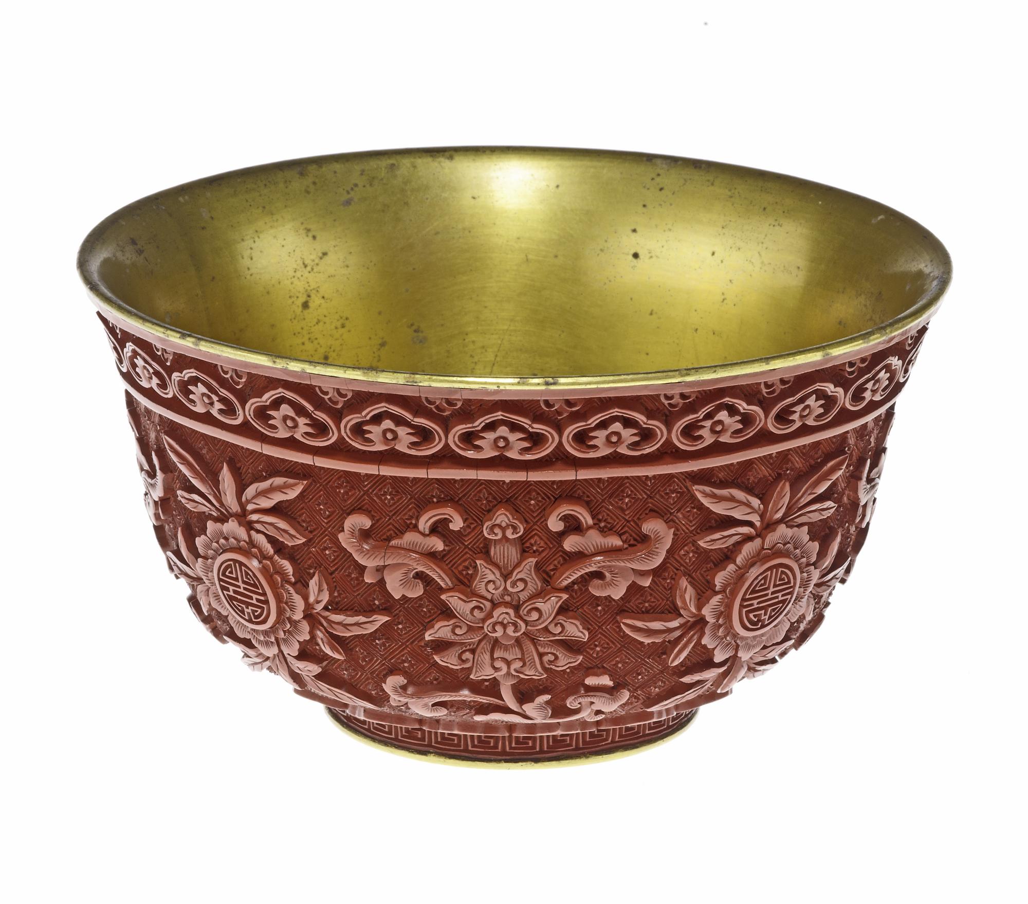 Ceremonial bowl of carved red lacquer on gilt metal, with alternate sprays of lotus and peach blossom and the longevity character Shou: China, Qing dynasty, Qianlong reign, 1736-95.