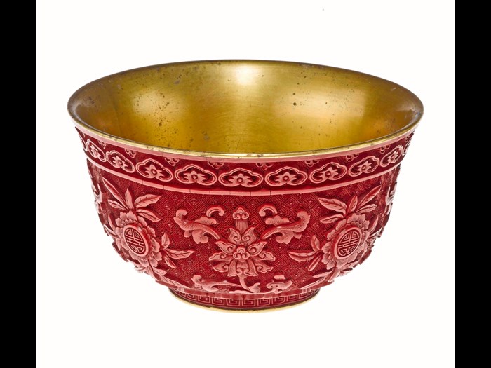 Ceremonial bowl of carved red lacquer on gilt metal, with alternate sprays of lotus and peach blossom and the longevity character Shou: China, Qing dynasty, Qianlong reign, 1736-95.