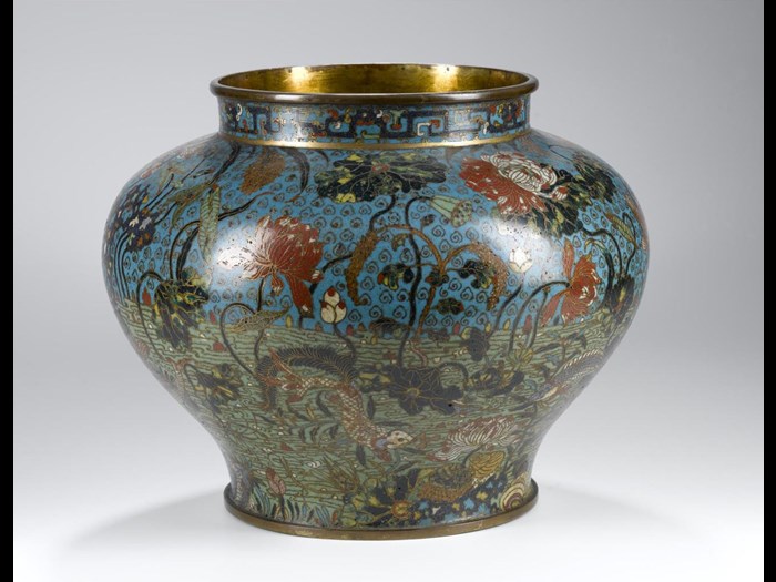Vase of cloisonne enamel on copper, in colours with fishes among lotus and other aquatic plants, and border of interlocking dragon strapwork design round neck, probable original lid now missing: China, Ming dynasty, 16th century.