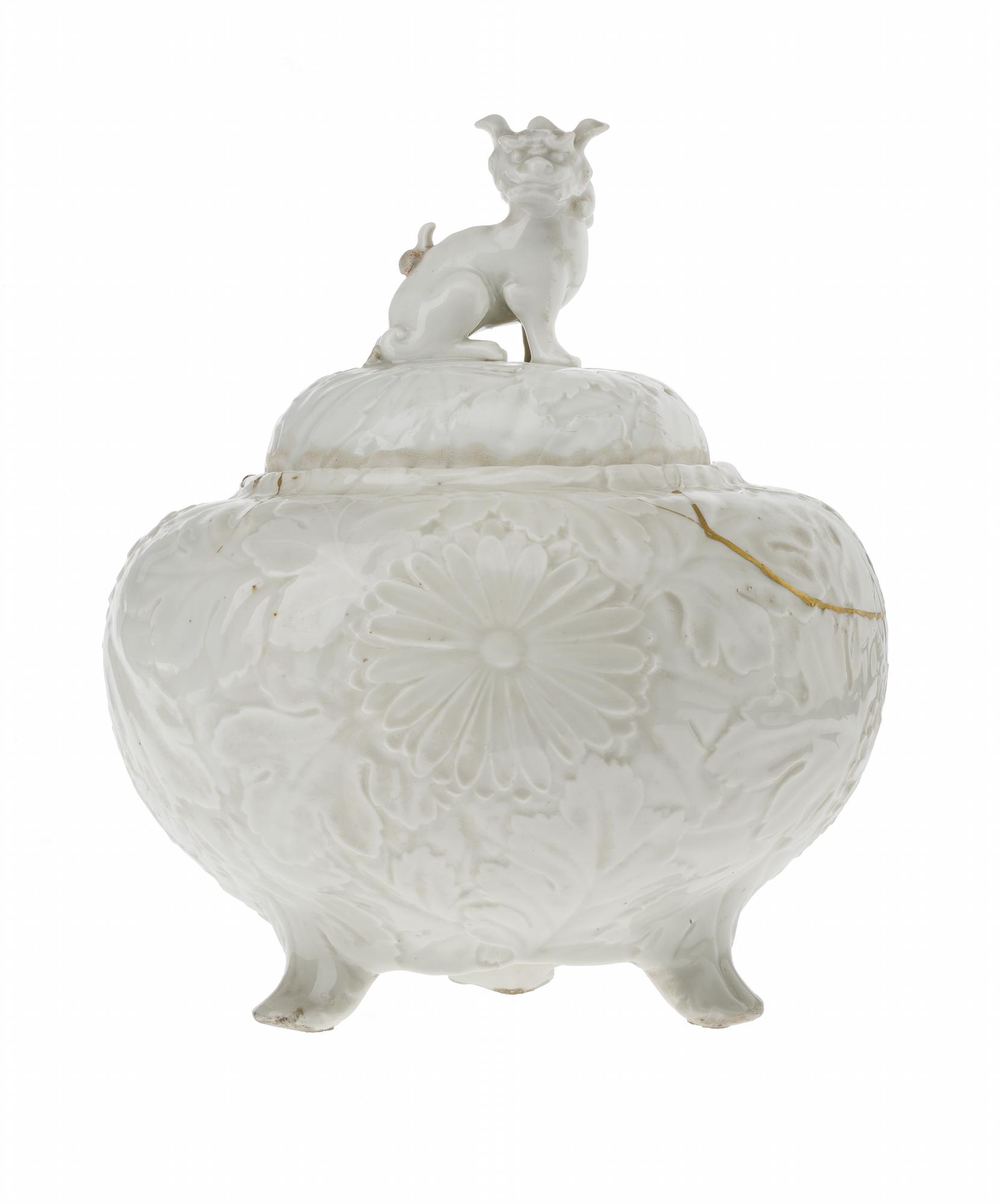 Jar and cover of porcelain with white glaze, bulbous and tripod, moulded with chrysanthemums in relief, lion-dog knop on cover, broken and repaired with gold lacquer: Korea, 18th century.