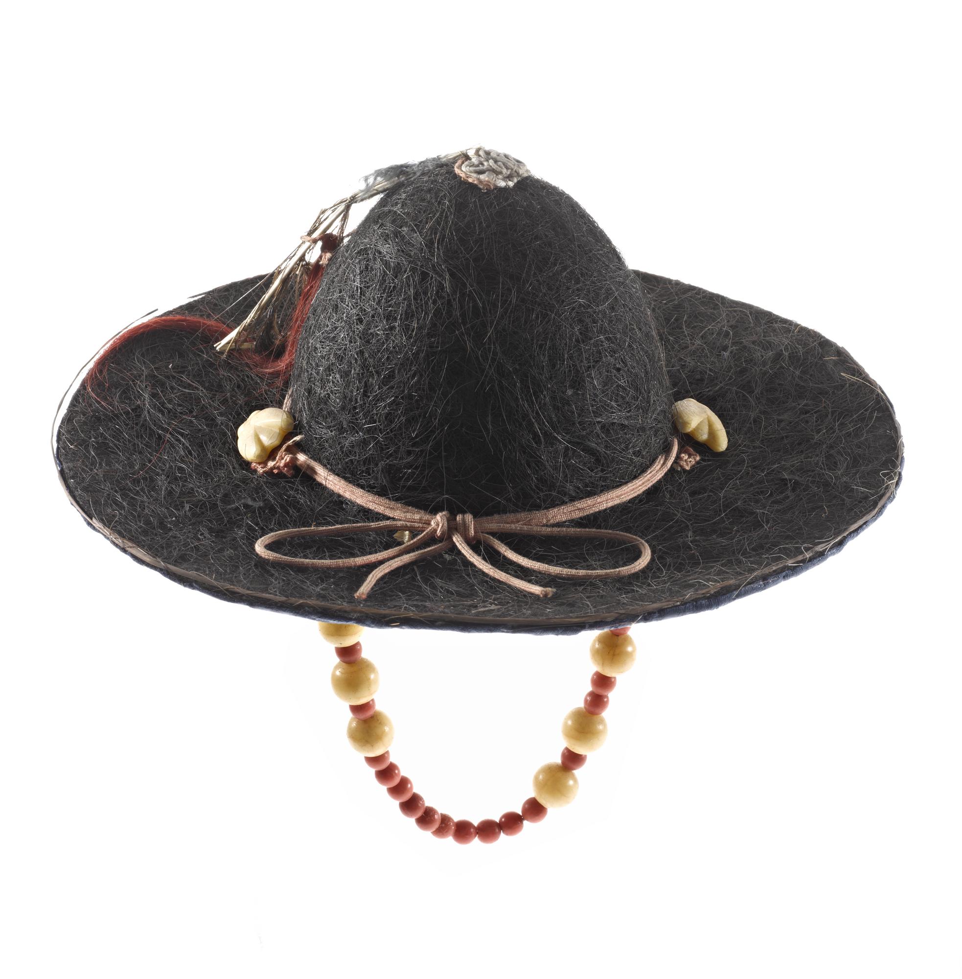 Royal courier's hat (jeonrip) made of cow-hair with a chin-band of beads, a peacock feather and red cord: Korea.