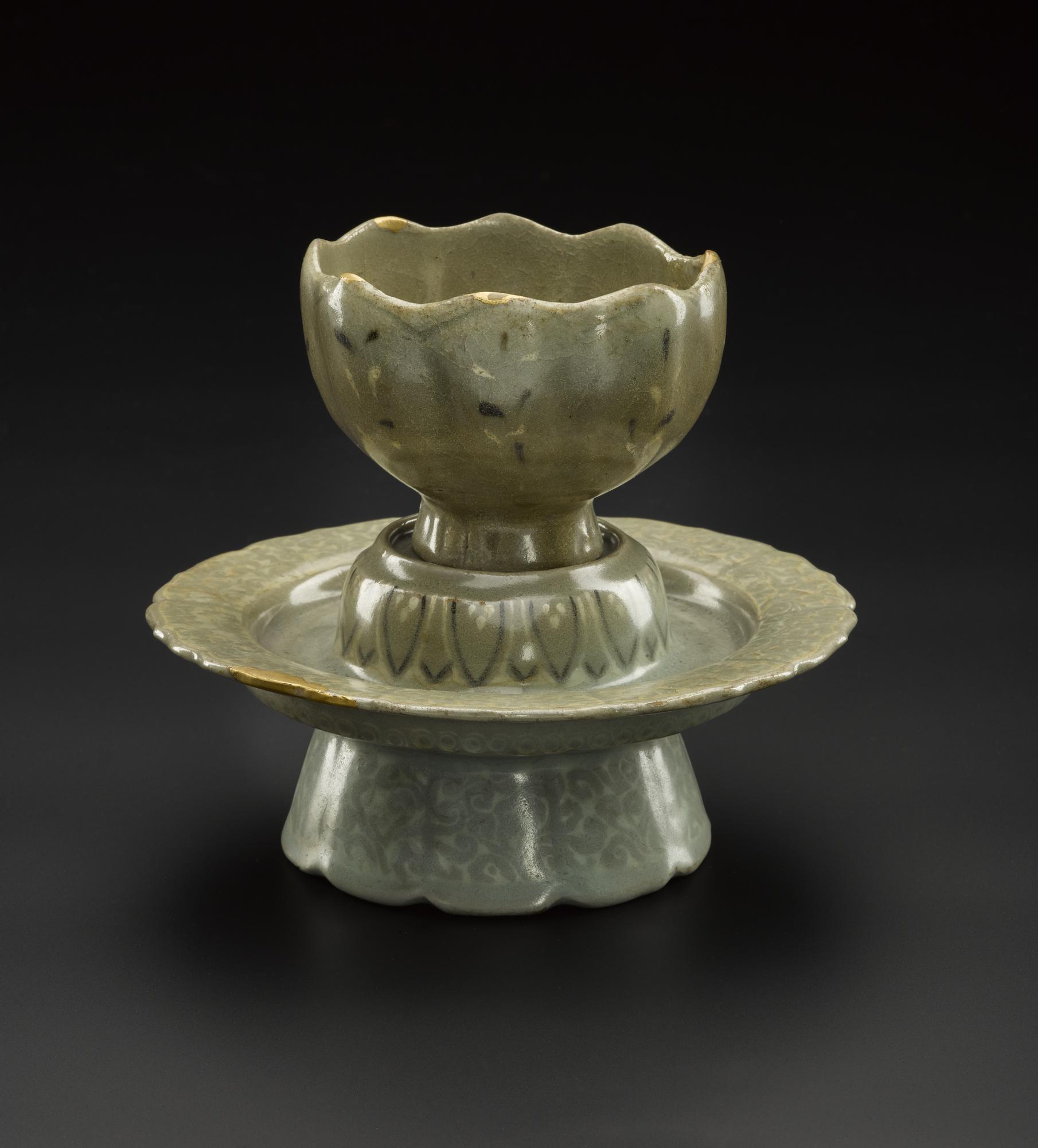 Lotus-shaped cup and stand of stoneware, decorated with inlaid designs in white and brown slip under a blue-green glaze: Korea, Goryeo Dynasty, 918 - 1392 AD.