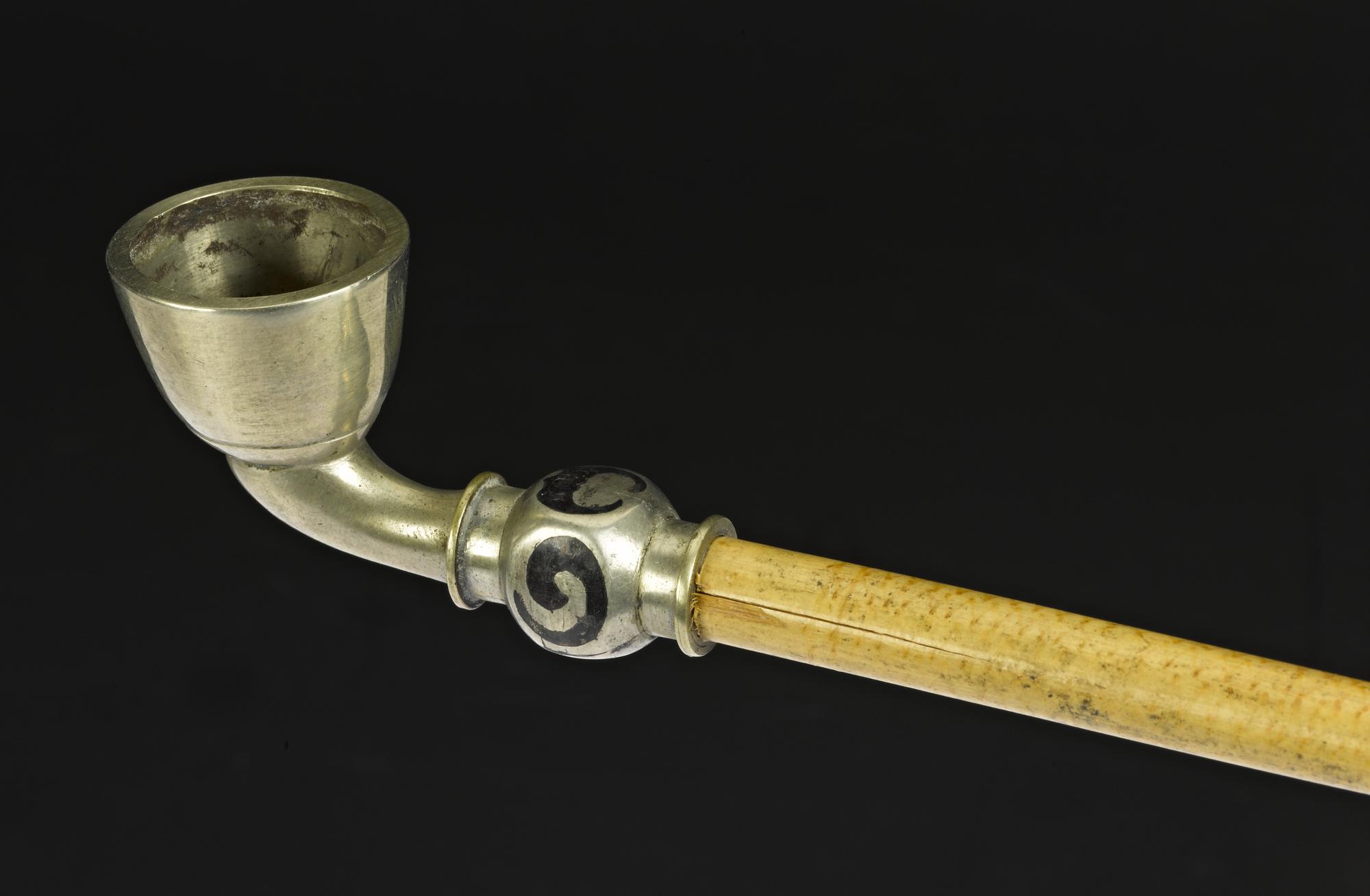 Tobacco-pipe with a metal bowl and mouthpiece, and a cane stem: Korea.