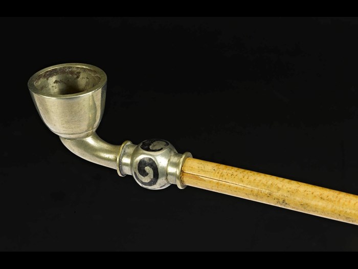 Tobacco-pipe with a metal bowl and mouthpiece, and a cane stem: Korea.