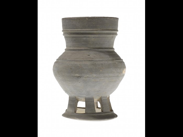 Vase of grey stoneware, with an oblate body on a perforated foot: Korean, excavated in Japan, Mino province, Kinsho village, Dolmen period.