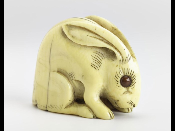 Netsuke of carved ivory, a hare, signed: Japan, by Tomotada.