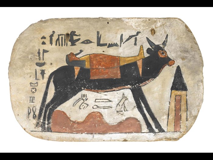 Footboard of wood, from cartonnage coffin or mummy-case, depicting the Apis bull carrying the mummy of the deceased, named as Pamiu, striding over the desert towards a pyramidal tomb: Ancient Egyptian, from Thebes, Upper Egypt, 3rd Intermediate Period, 22nd Dynasty, Osorkon III, 790-762 BC.