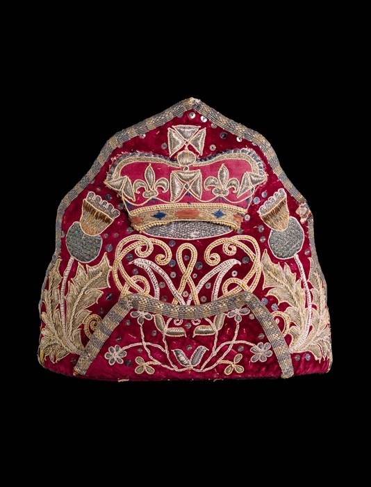 Officer's mitre cap of a Scottish grenadier unit in the army of William III. The Scottish identity is shown by thistles at either side of the royal crown and cypher of King William and Mary.