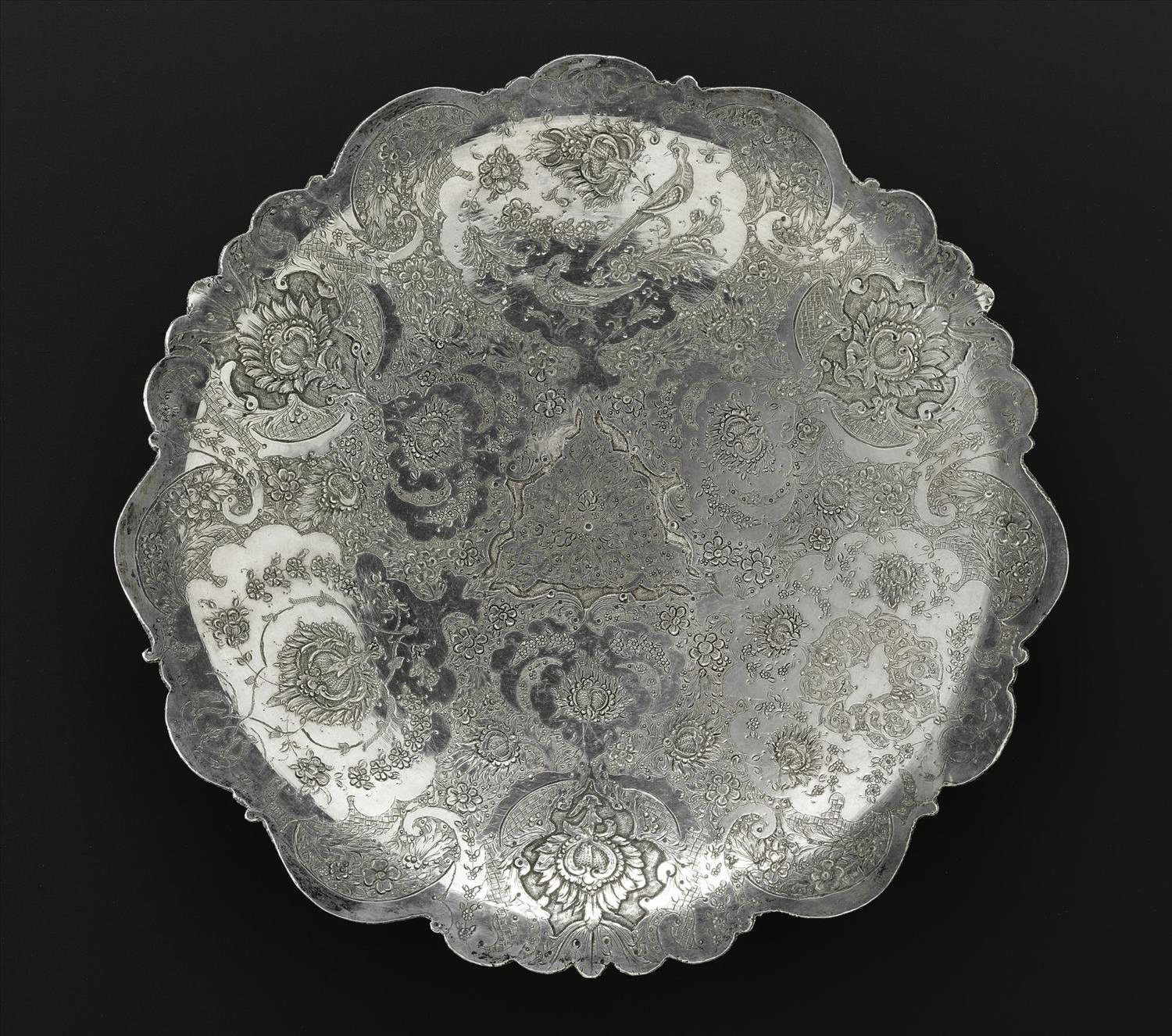 Circular dish of silver, shallow, engraved with floral decoration and two birds, one above the other, in the top centre medallion, hallmarked on the reverse, Iran, probably Isfahan, 1920s-1940s, acc. no V.2015.60