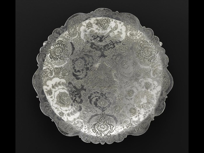 Circular dish of silver, shallow, engraved with floral decoration and two birds, one above the other, in the top centre medallion, hallmarked on the reverse, Iran, probably Isfahan, 1920s-1940s, acc. no V.2015.60