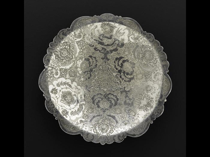 Circular dish of silver, shallow, engraved with floral decoration and three birds depicted in profile in the top centre medallion, hallmarked on the reverse, Iran, probably Isfahan, 1920s-1940s, acc.no V.2015.61