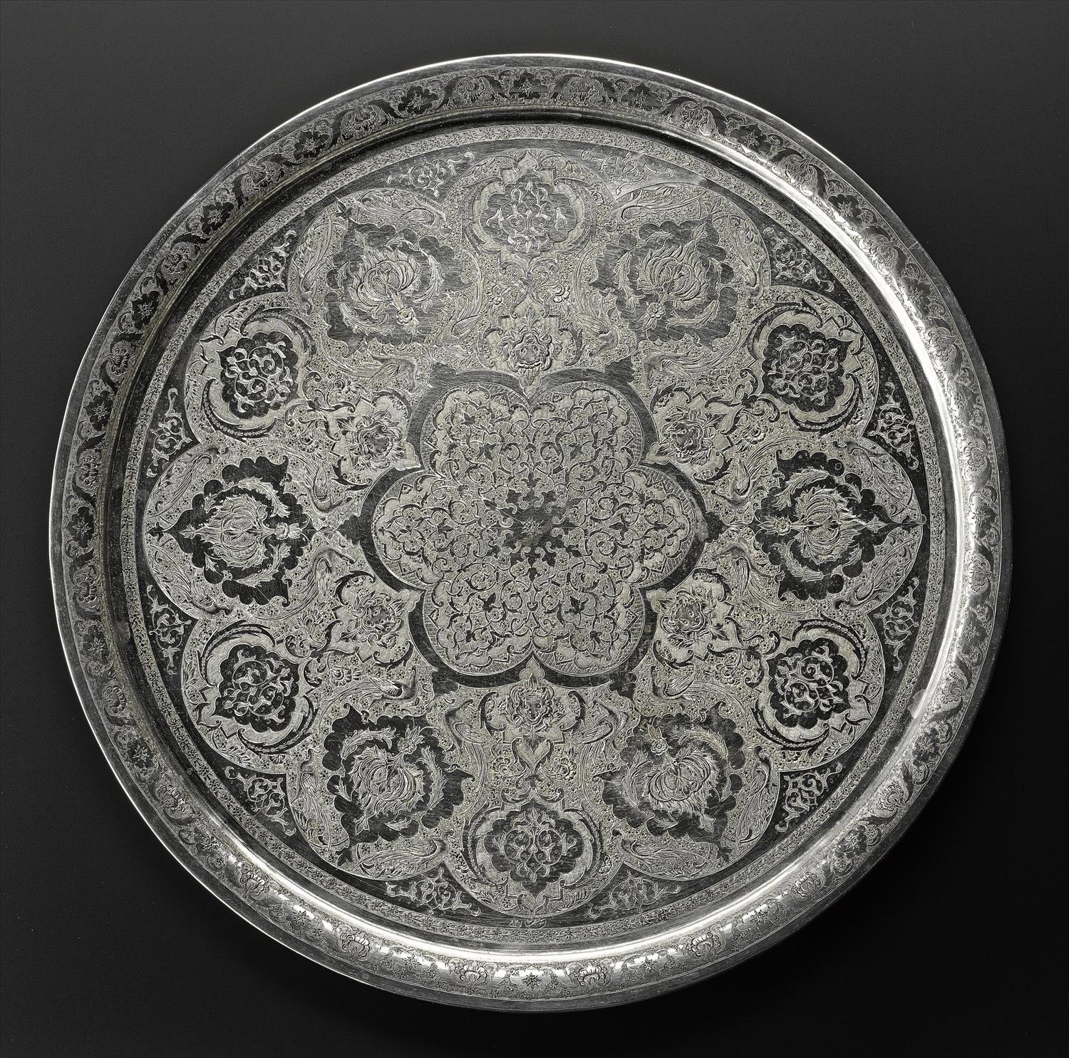 Circular tray of silver with a chased pattern of stylized floral motifs and animals, hallmarked on the front, Iran, probably Isfahan, 1920s-1940s, acc. no V.2015.62