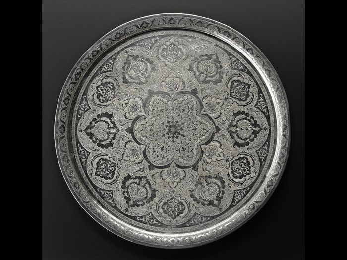 Circular tray of silver with a chased pattern of stylized floral motifs and animals, hallmarked on the front, Iran, probably Isfahan, 1920s-1940s, acc. no V.2015.62