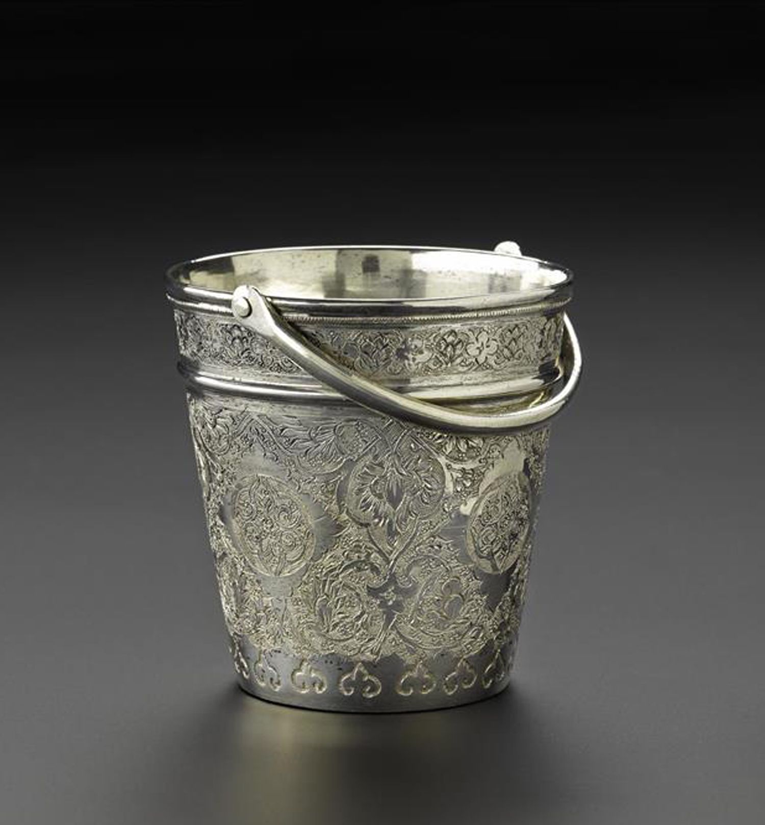 Miniature ice bucket of silver, with a handle and floral decoration around the outside, Iran, probably Isfahan, 1920s-1940s, acc. no V.2015.67