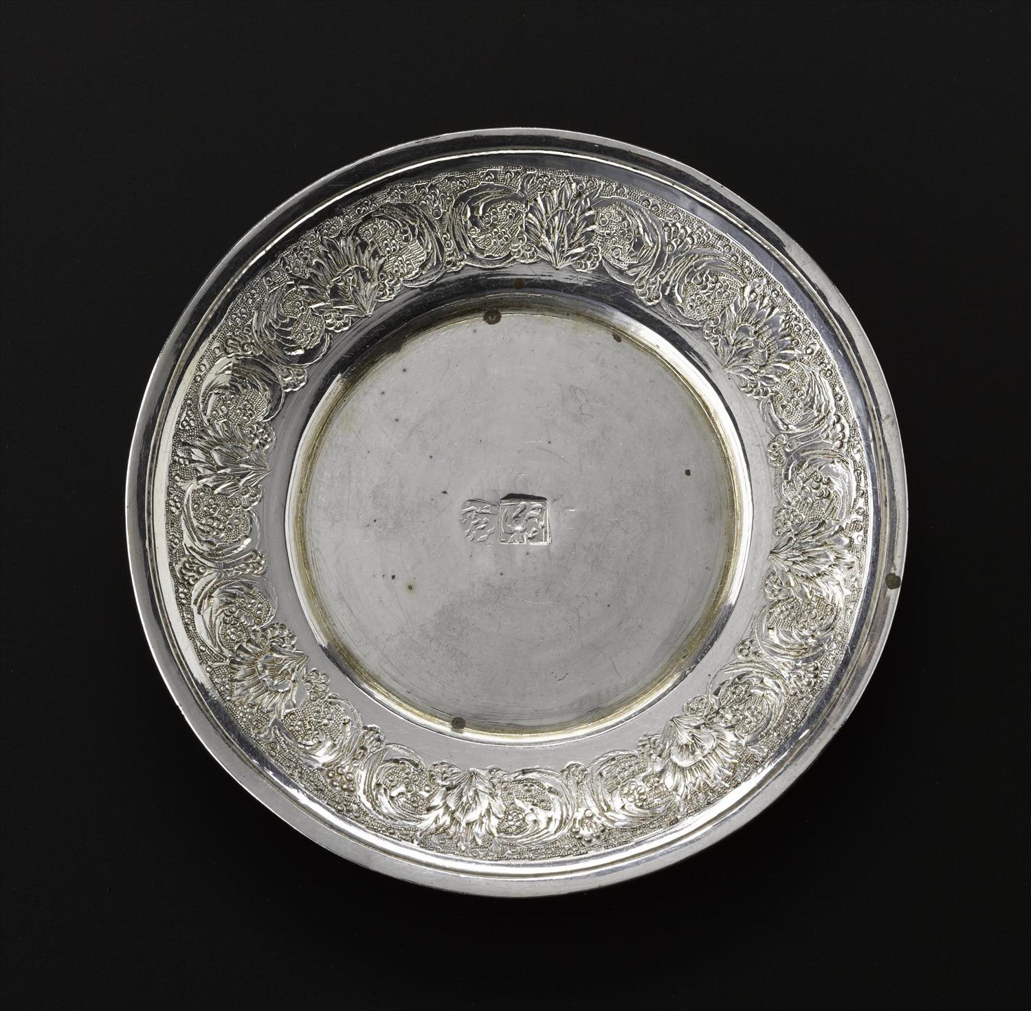Miniature saucer of silver with floral decoration around the outside rim and hallmarked in the centre, part of a set with a cup and a spoon, Iran, probably Isfahan, 1920s-1940s, acc. no V.2015.68.2