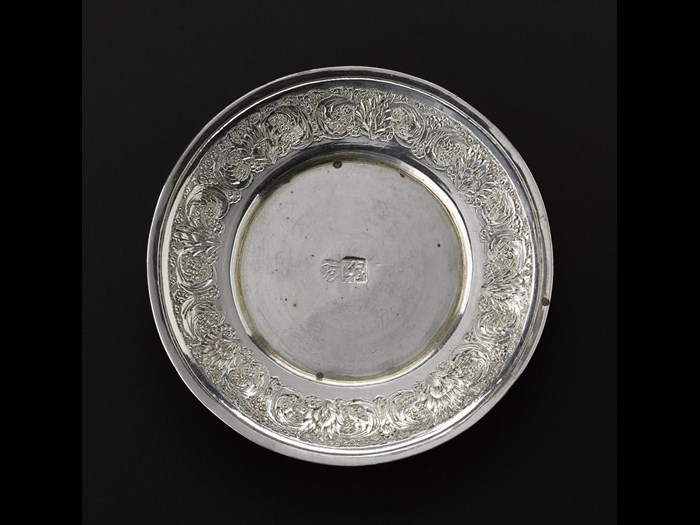 Miniature saucer of silver with floral decoration around the outside rim and hallmarked in the centre, part of a set with a cup and a spoon, Iran, probably Isfahan, 1920s-1940s, acc. no V.2015.68.2