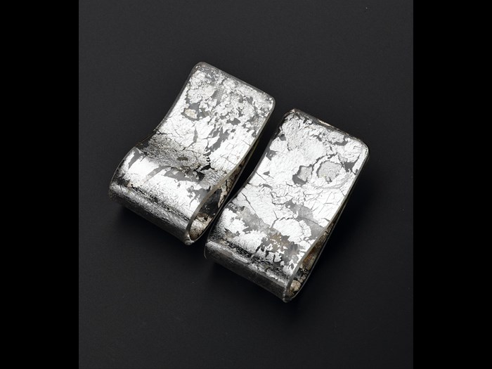 Clip-on earrings of transparent acrylic decorated with silver leaf: British, designed and made for Jean Muir Ltd by C & N Buttons & Jewellery Production, 1980s.