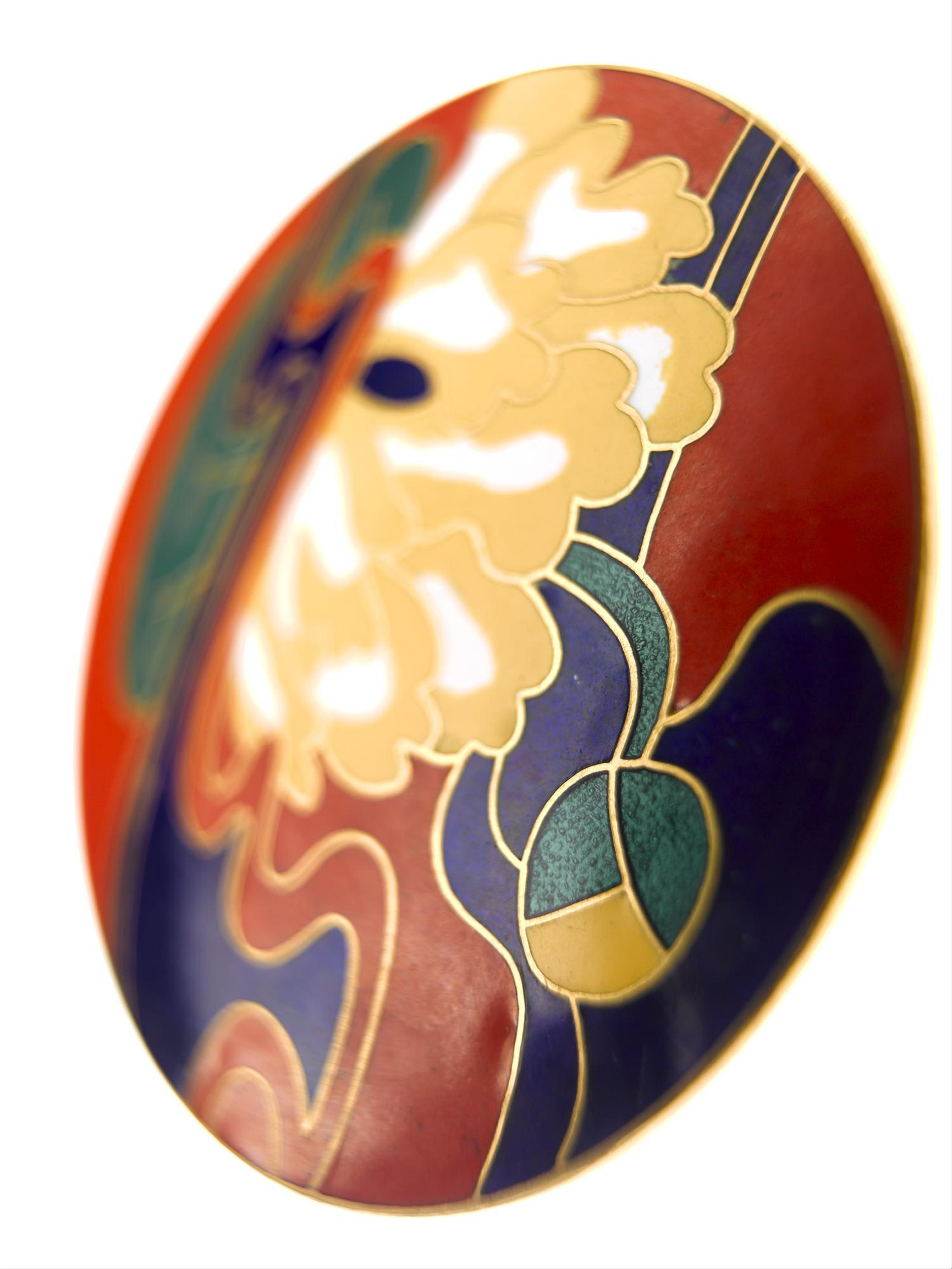 Large circular belt buckle of silver gilt featuring a Japanese style lotus flower design in coloured enamel inlay: British, designed for Jean Muir Ltd by Marks of Distinction, c. 1972.