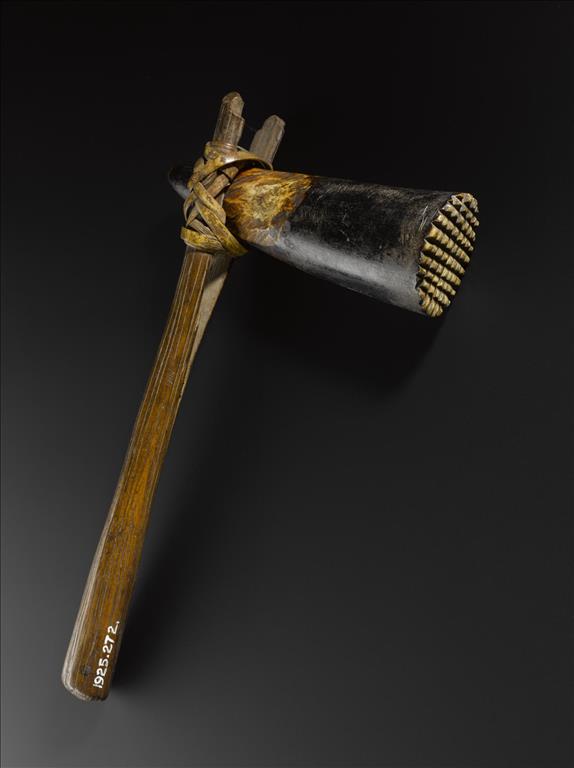 Barkcloth beater with wooden haft, with cross-hatched blackened tip of an elephant's tusk lashed into position by a strip of cane: Africa, Central Africa, Democratic Republic of the Congo, early 20th century.