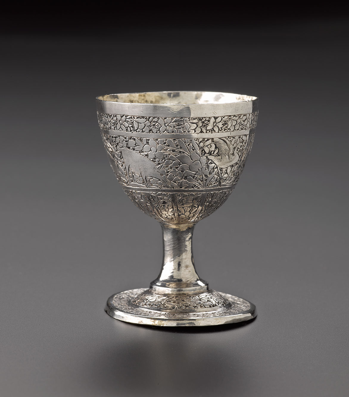 Egg cup of silver, with chased decoration of animals and floral motifs around the outside and base: Iran, probably Isfahan, 1920s-1940s, acc. no V.2015.66 