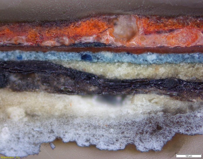 Cross section showing the original paint layers and the numerous subsequent repaints on the Virgin’s robe.