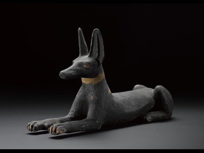 Statuette of a jackal in wood, painted black, with eyes and brows outlined in red, probably originally from the lid of a qrsw-coffin: Ancient Egyptian, excavated at Sheikh Abd el-Qurna, Thebes, 25th-26th Dynasty, Third Intermediate Period, c.747-525BC.