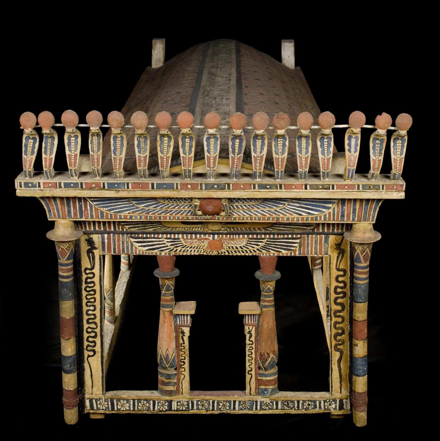 Canopy of sycamore-fig wood painted in red, black, blue, yellow and white in the shape of a shrine, with an arched roof and corner-posts : Ancient Egyptian, excavated at Sheikh Abd el-Qurna, Thebes, c.9BC.
