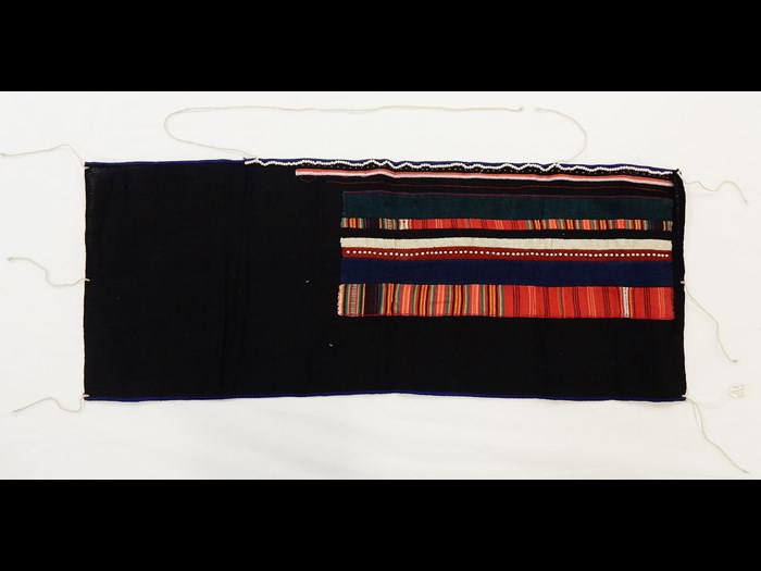 Woman's black cotton bodice decorated with striped cotton applique with borders of white beads, worn under jackets: Asia, South East Asia, North Thailand, Chiangrai, Lawle or Amphur Maechan, Akha people, by Mina, 1984.