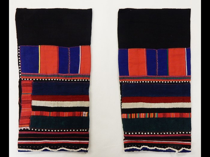 Woman's black cotton leggings decorated with panels and stripes in cotton applique with white beads: Asia, South East Asia, North Thailand, Chiangrai, Lawle or Amphur Maechan, Akha people, by Mina, 1984.