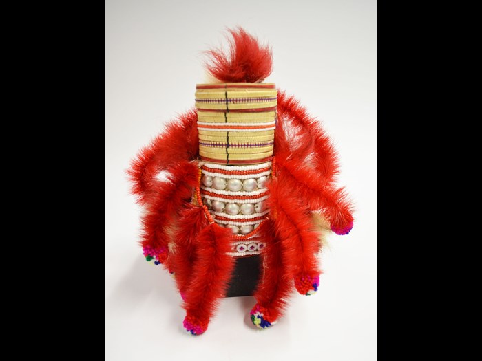 Woman's hat of cream cotton fabric stretched over a conical cane mount and decorated with strips of plaited straw, beads, tin studs, streamers of monkey fur and chicken feathers: Asia, South East Asia, North Thailand, Chiangrai, Lawle, Amphur Maechan, Akha people, by Mina, 1984.