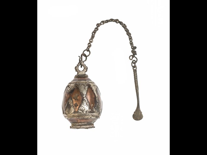 Lime box of copper in hinged halves, with chased silver triangle inlay and silver mounts, and a silver spatula attached by a silver chain, for holding lime used in betel chewing: Asia, South Asia, Sri Lanka, Sinhalese, 19th century.