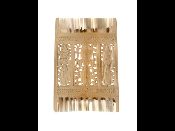 Comb of ivory with two rows of teeth, the front central portion divided into three panels each carved with the figure of a standing female deity with a halo behind the head, the back similar but less carefully finished: South Asia, Sri Lanka, Kandy, 18th - 19th century.