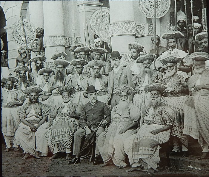 Sir Everard im Thurn seated in the centre of a group of men from the ruling elite in Kandy, Sri Lanka
