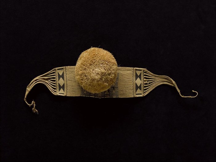 Waistbelt of woven patterned grass fibre with large 'pom-pom' worn by women: Africa, Central Africa, Democratic Republic of the Congo, from a village near Itoko, early 20th century.