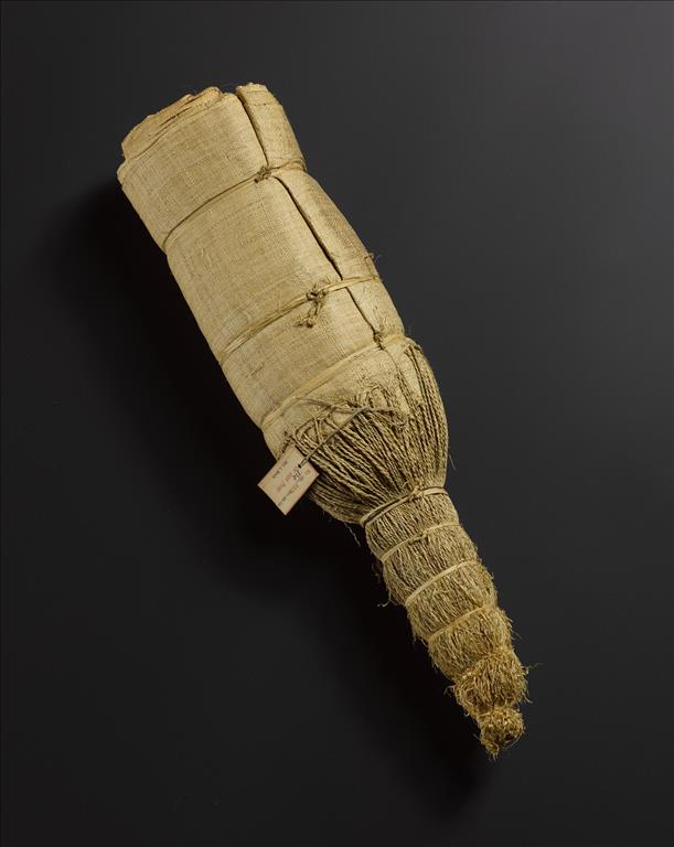 Woven raffia fringed skirt rolled and tied with raffia in a bundle, used as a standard of value for trade and exchange: Africa, Central Africa, Democratic Republic of the Congo, early 20th century.