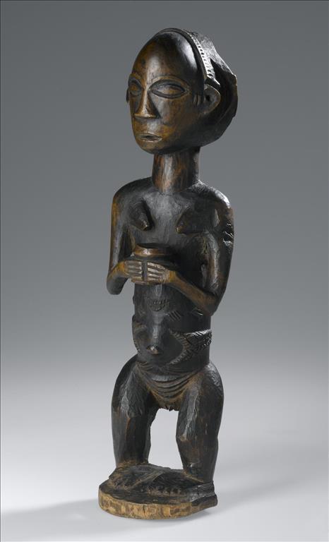 Carved wooden standing female figure  with dressed hair and body scarification, holding a jar with both hands: Africa, Central Africa, Democratic Republic of the Congo, Katanga, late 19th century.