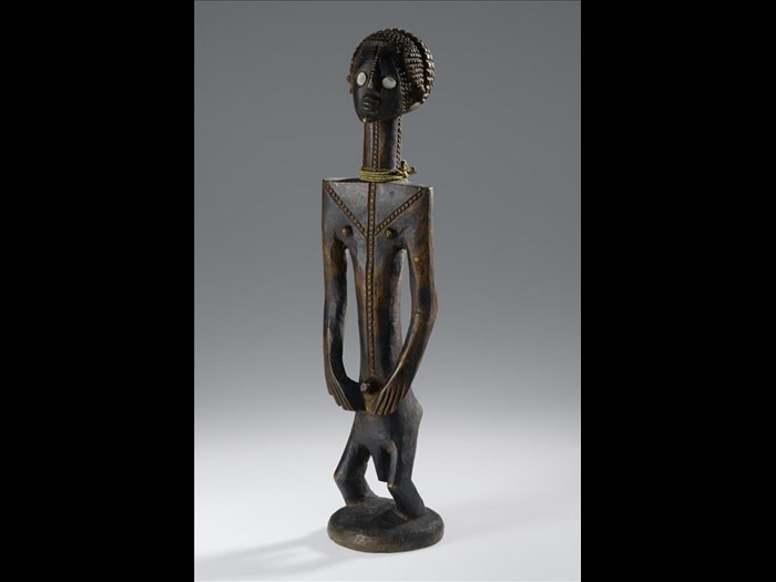 Carved wooden male figure with elongated body, hands on hips, bent knees, elaborate hair style, facial and body scarification decoration and shell eyes: Africa, Central Africa, Democratic Republic of the Congo, Katanga Province, Tabwa people, late 19th century.