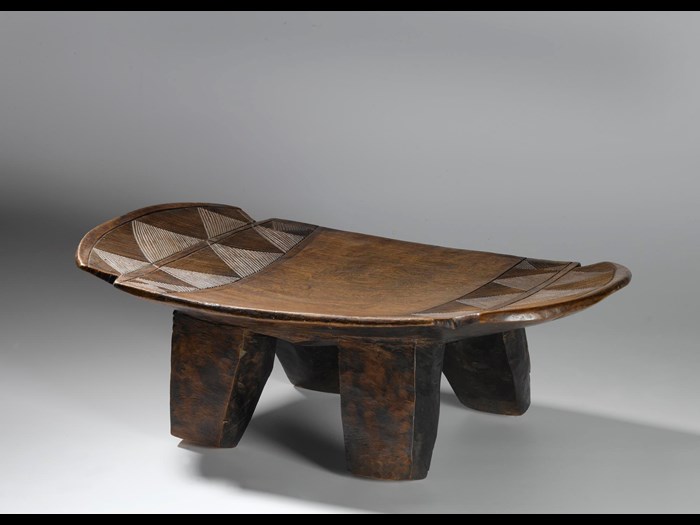 Slightly curved oblong wooden stool on four legs, with carved linear ornament: Africa, Southern Africa, Zambia, Tanganyika Plateau, Awemba, late 19th century.