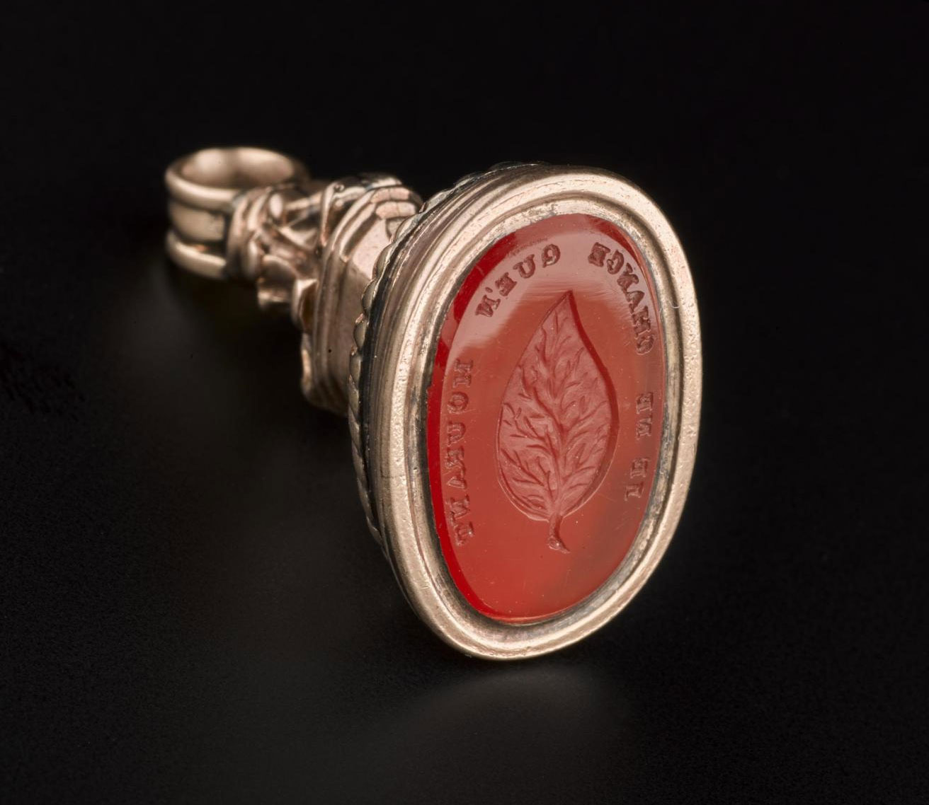 Gold and gemstone fob seal engraved with a leaf and the motto 'Je Ne Change Que'n Mourant', meaning 'I do not change except in death' – an expression of steadfast loyalty. 