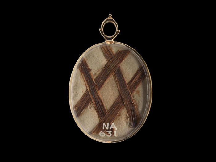 Four pieces of the prince's hair are attached to the reverse of this gold locket.