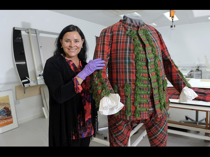 Diana Gabaldon with a tartan suit that belonged to English Jacobite Sir John Hynde Cotton.