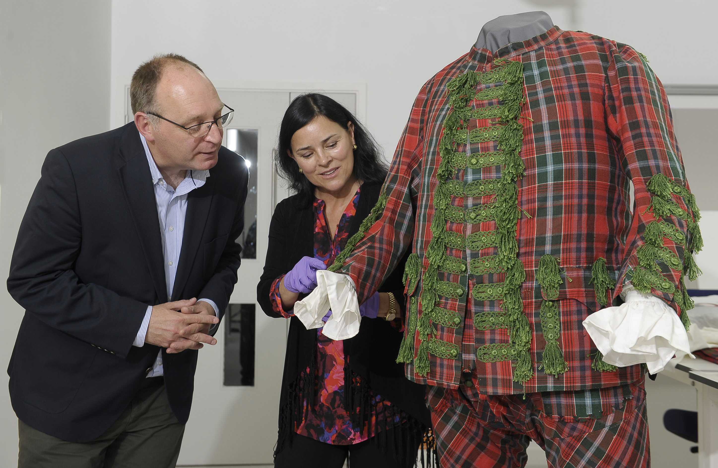 Diana Gabaldon and Principal Curator David Forsyth investigate a tartan suit bound for the Bonnie Prince Charlie and the Jacobites exhibition.