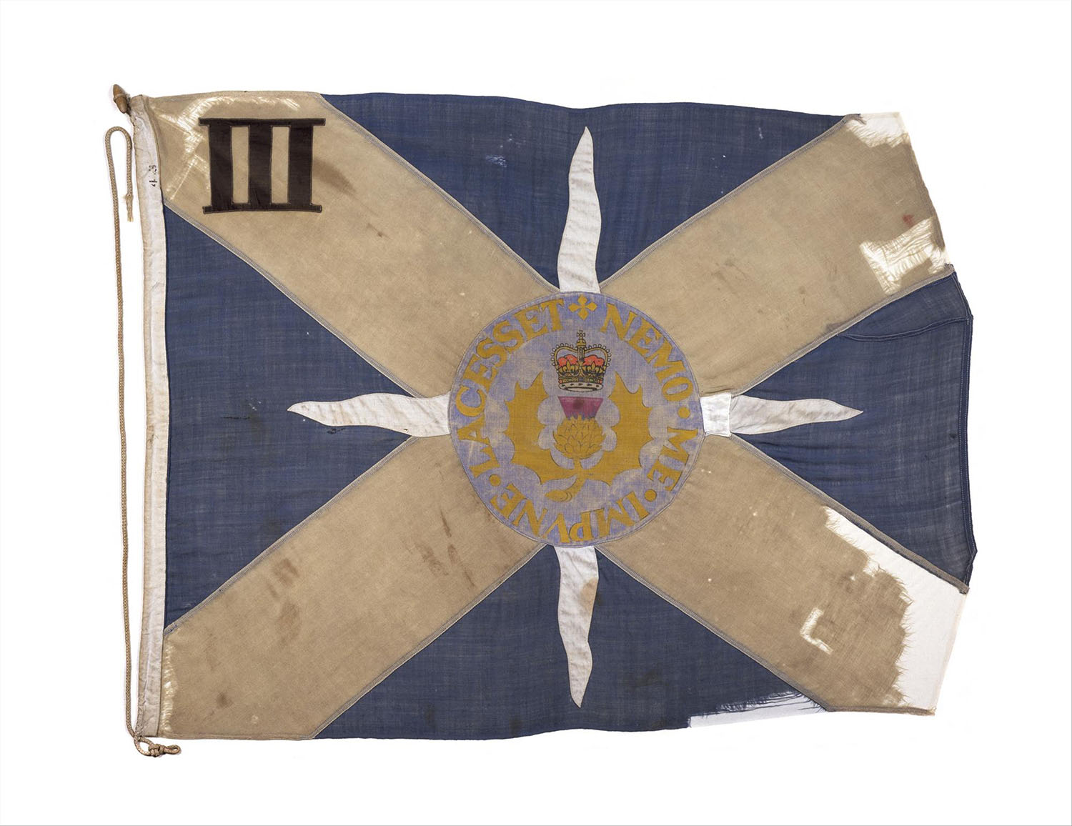 Company flag, Saltire with thistle and crown at centre and motto NEMO.ME.IMPVNE.LACESSET, flown while the battalion was serving in Northern Ireland, c.1975. On display in the National War Museum.