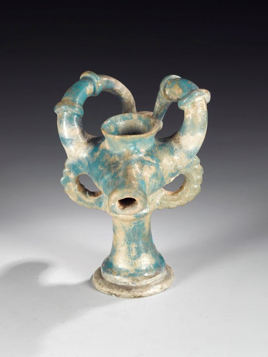 Lamp of ground quartz and clay with a transparent turquoise alkaline glaze, moulded in form of a stylised ibex head: Persia, Rayy type, late 12th to early 13th century