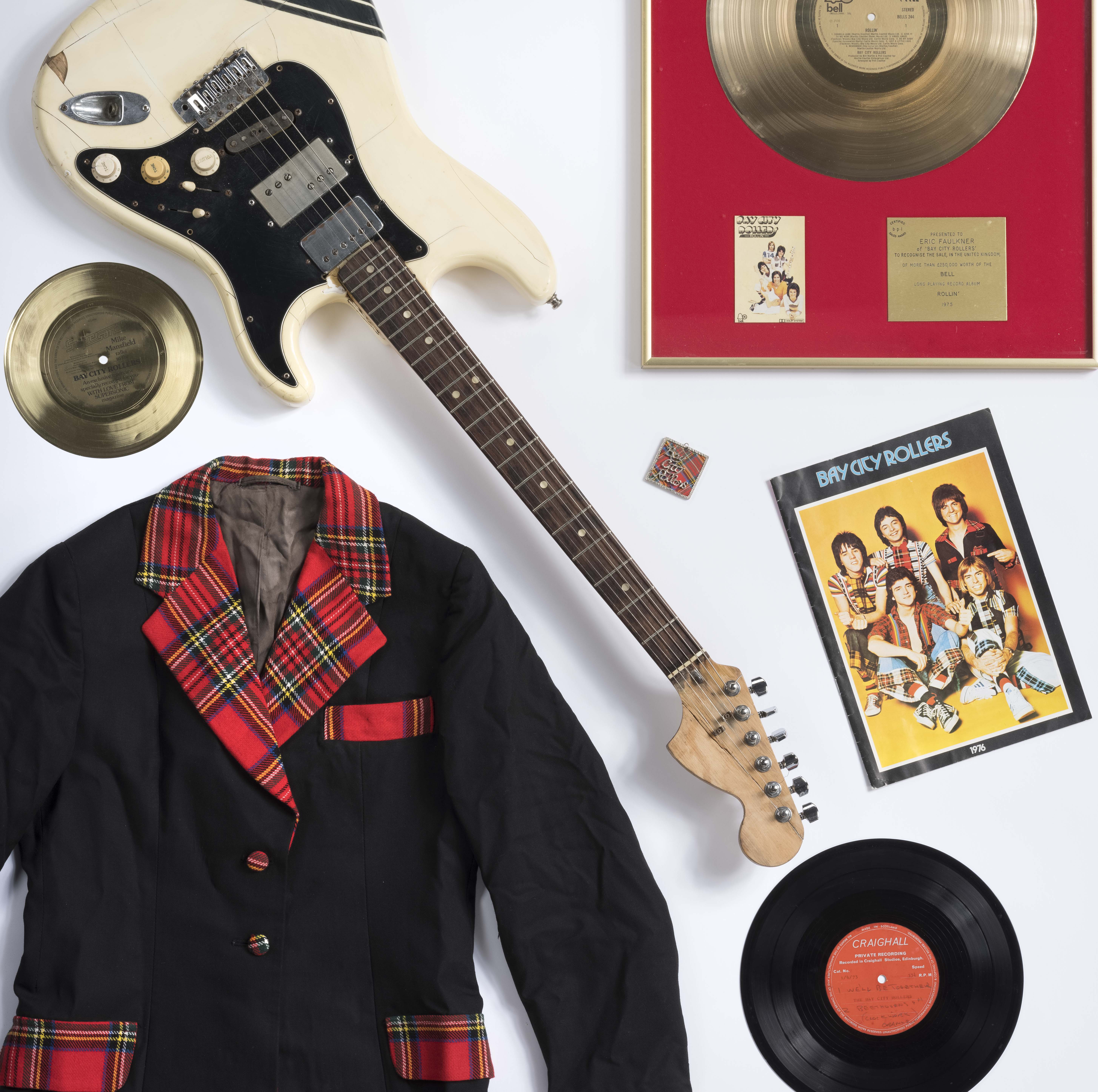 ‘Bay City Rollers jacket, 1976 tour programme, supersonic floppy disc and fan club badge on loan from a private collection; Bay City Rollers gold disc, guitar and earliest unreleased Bay City Roller acetate recording on loan from a private collection.